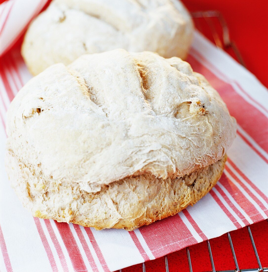 Freshly baked bread on a striped cloth