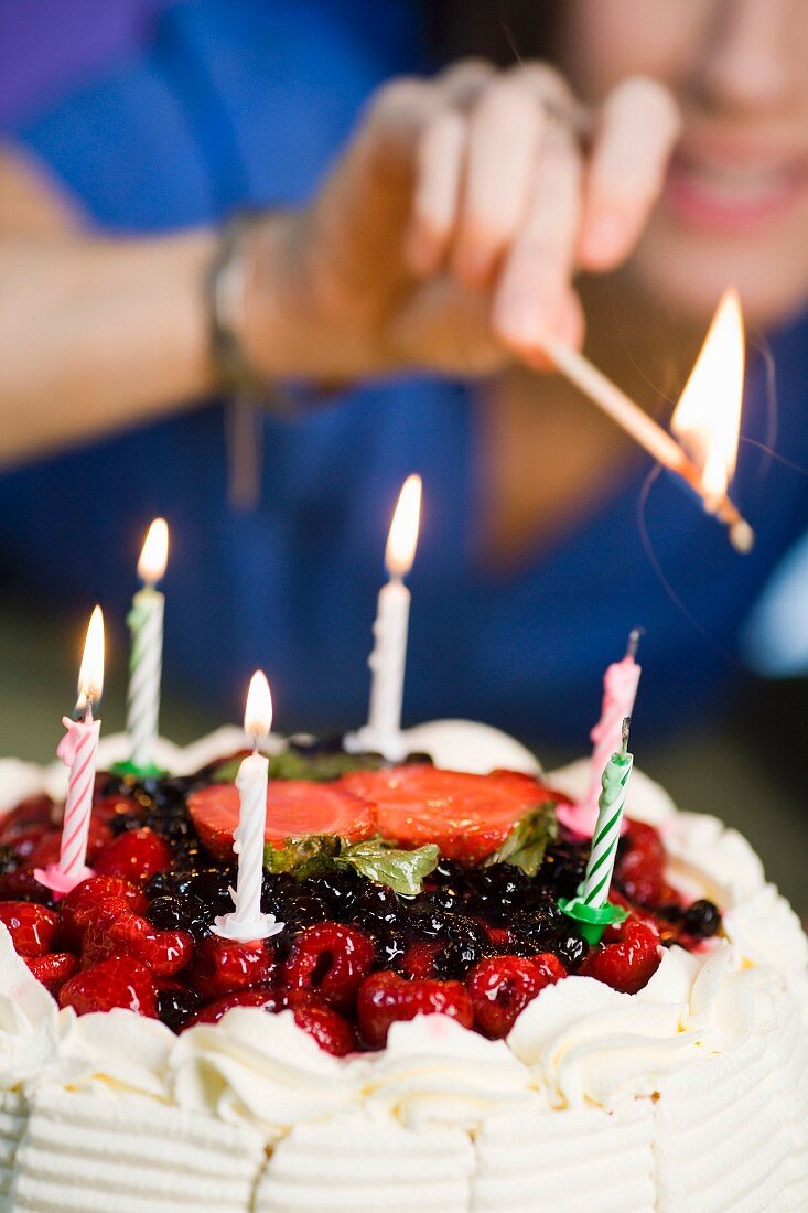 Birthday cake candles being lit