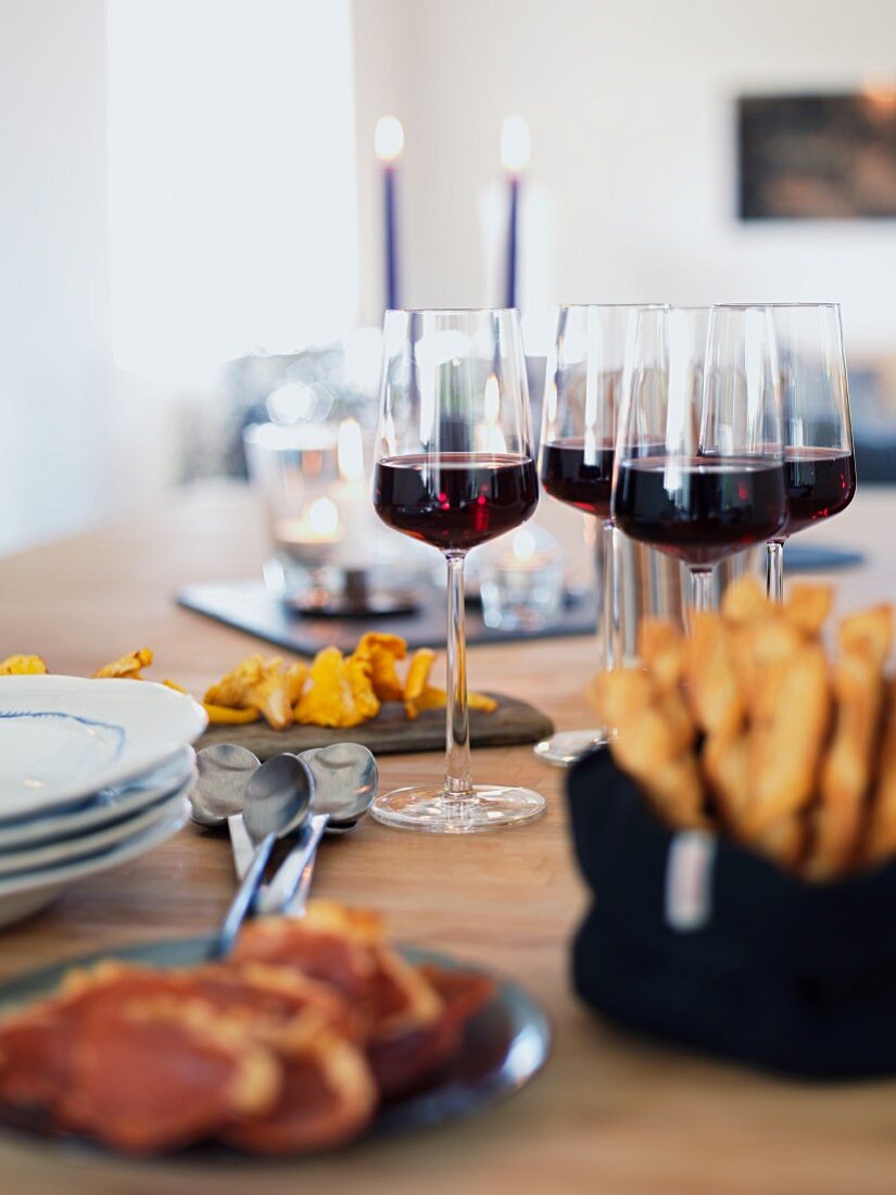 A table laid with appetizers and red wine