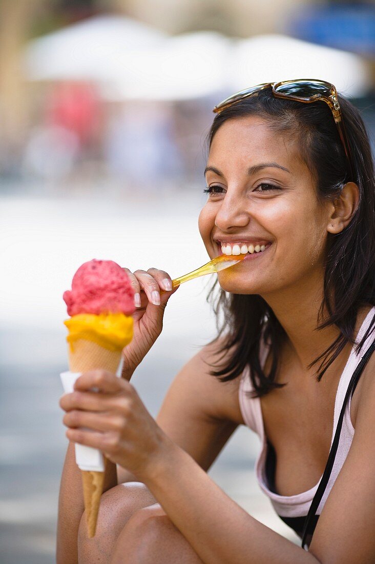A young woman eating an ice cream