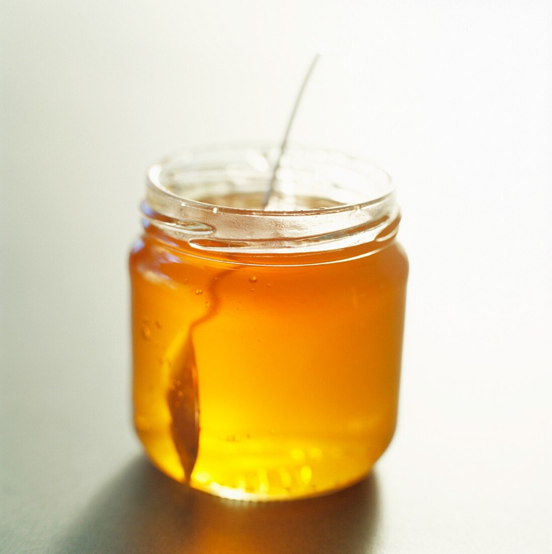Honigglas mit Löffel