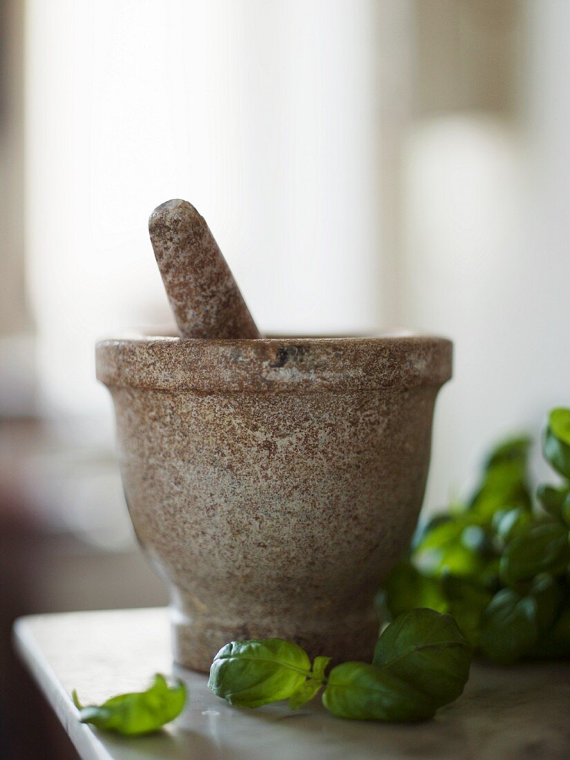 A mortar with basil