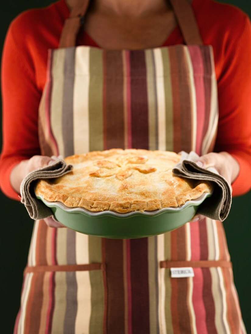 Woman holding freshly-baked pie