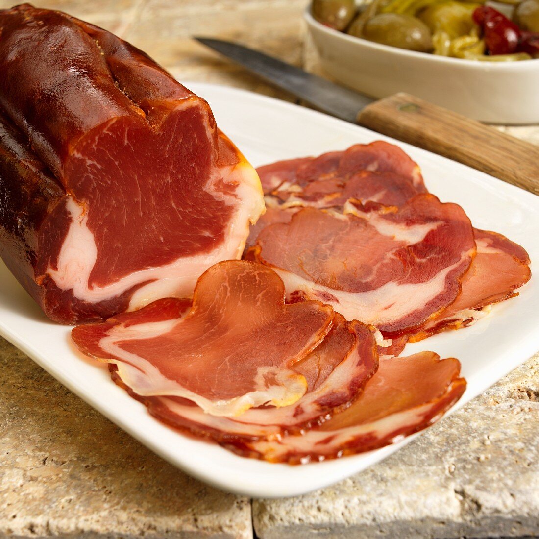 Partially Sliced Dried Cured Spanish Pork Loin on a Platter