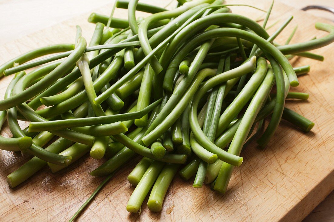 Garlic Scapes; The Green Part of the Garlic Plant; On Cutting Board