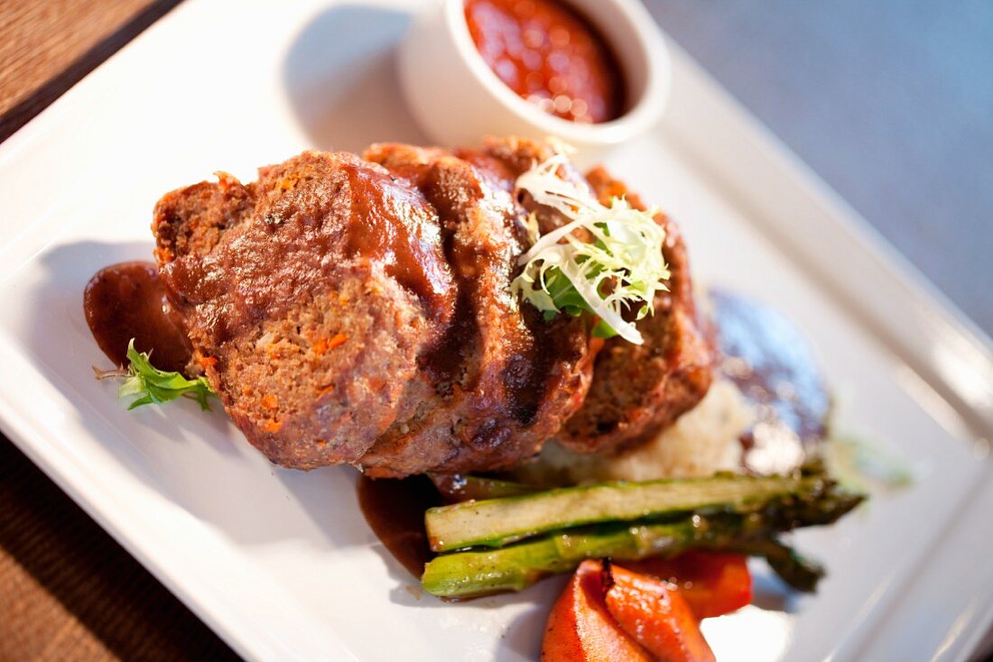 Meatloaf with Ketchup and Mashed Potatoes Served with Carrots and Asparagus