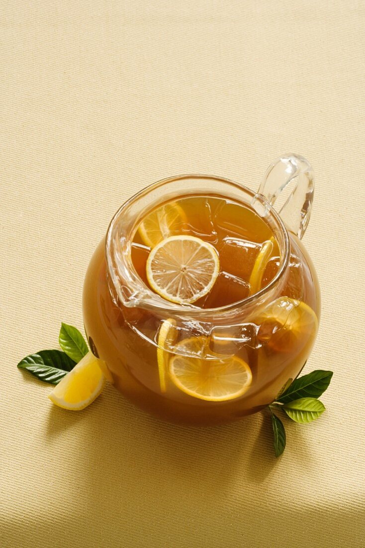 Pitcher of Iced Tea with Lemon Slices; Tea Leaves