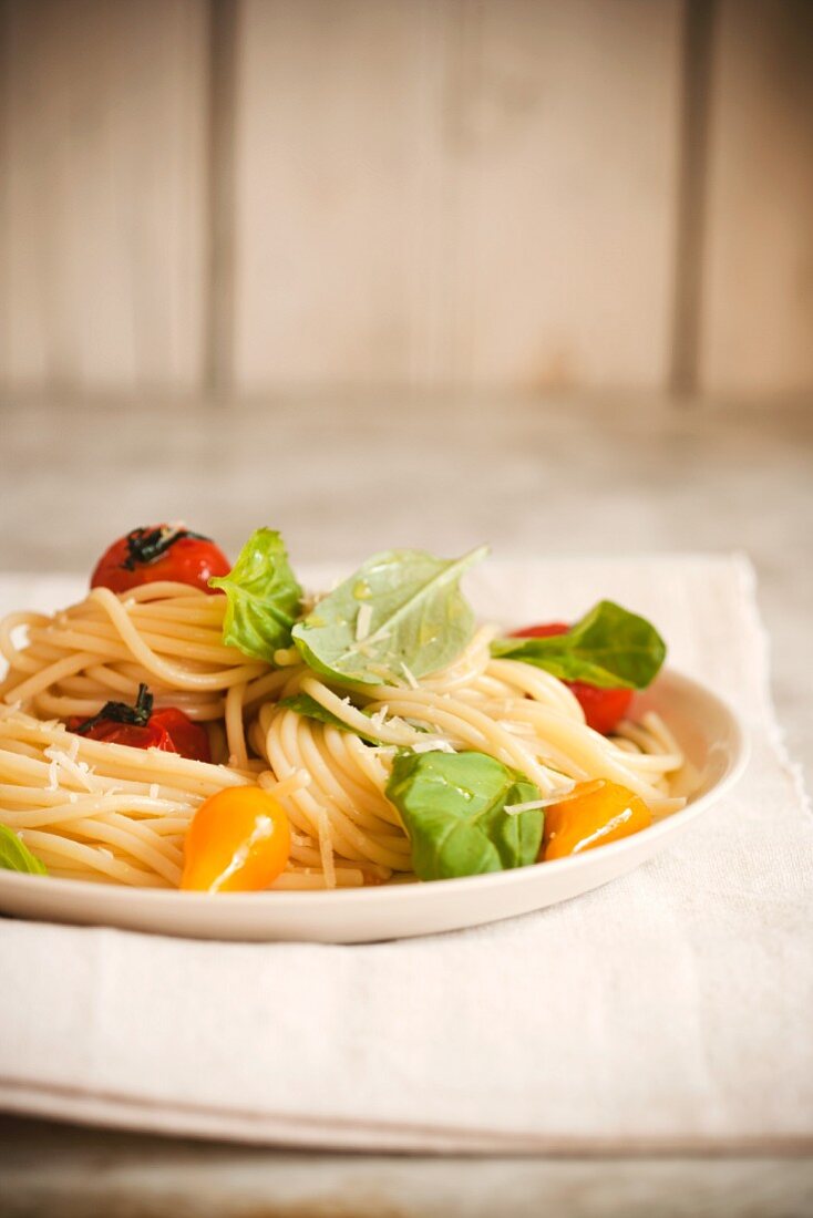 Spaghetti with Yellow and Red Tomatoes and Fresh Basil Leaves
