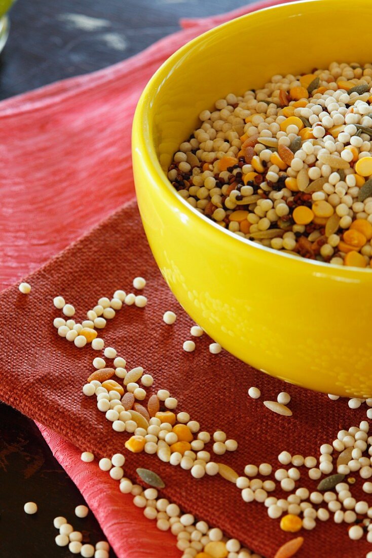 Uncooked Israeli Couscous in a Yellow Bowl