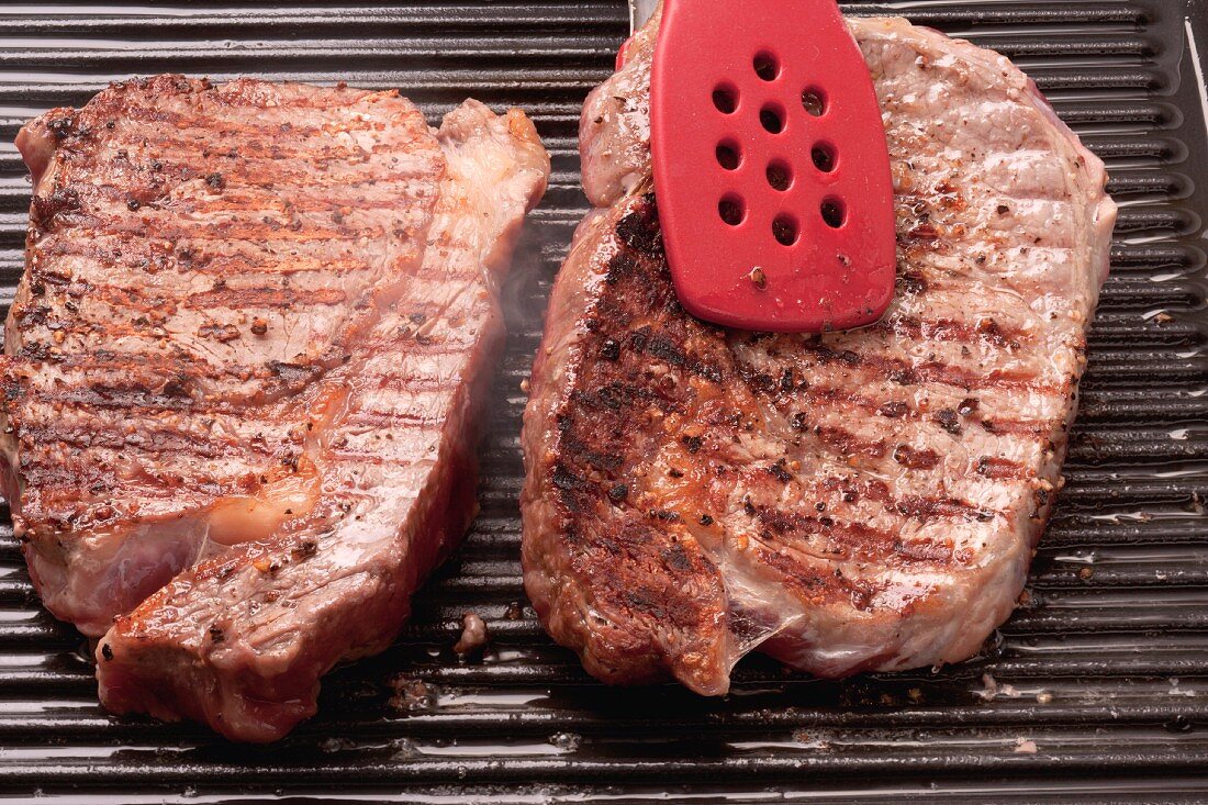 Ribeye steaks being grilled