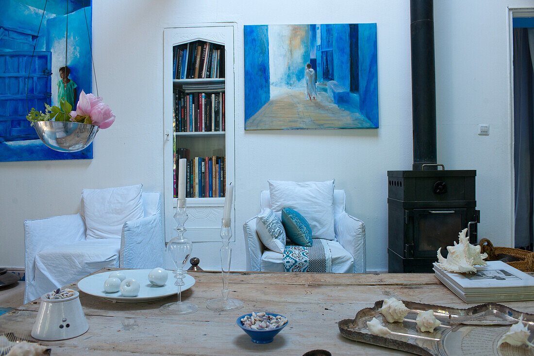 Living room with artwork in blue tones and fireplace