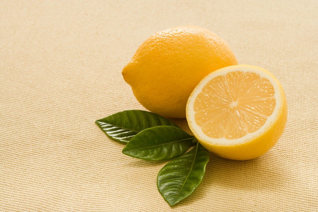 Whole and Half a Lemon with Fresh Tea Leaves