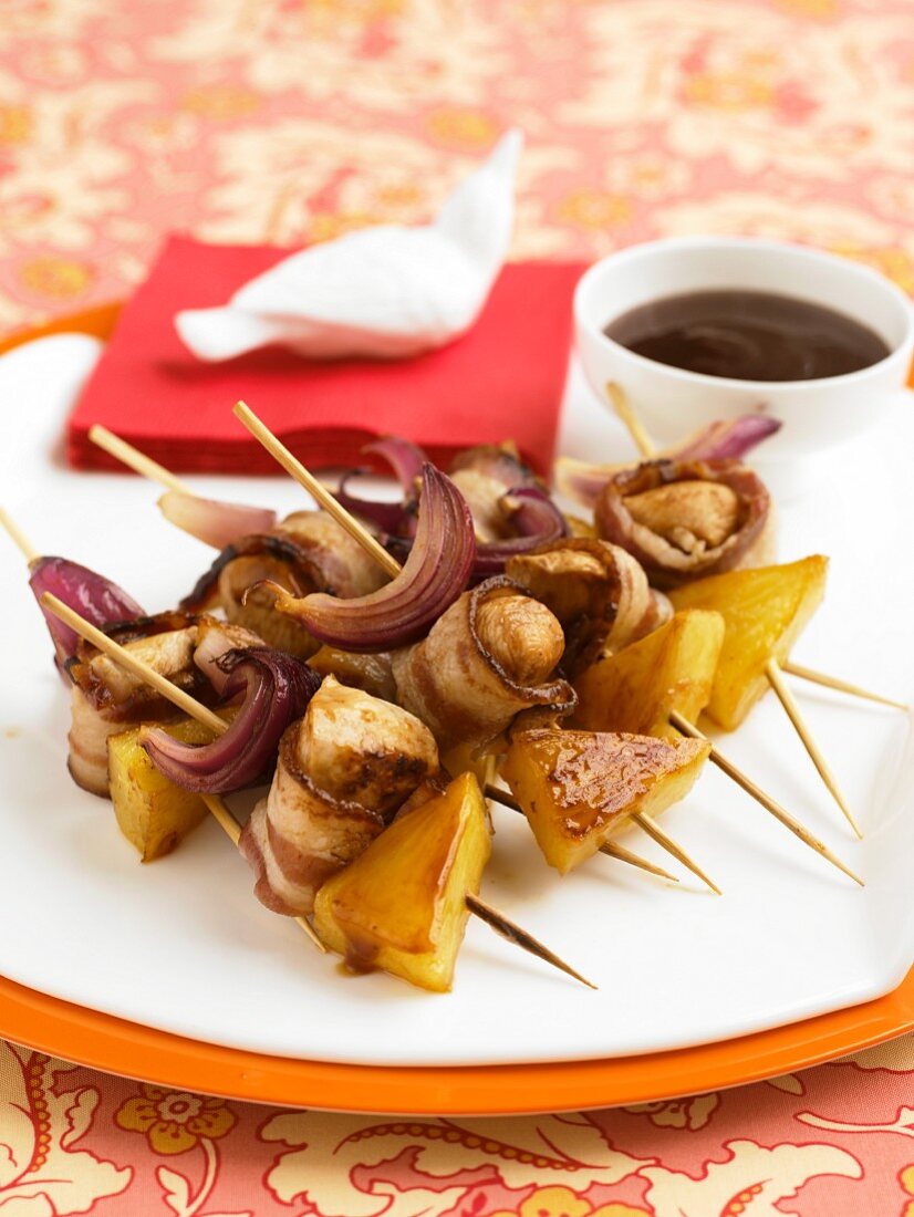 Skewered Chicken Wrapped in Bacon with Pineapple Chunks, Red Onion and Dipping Sauce