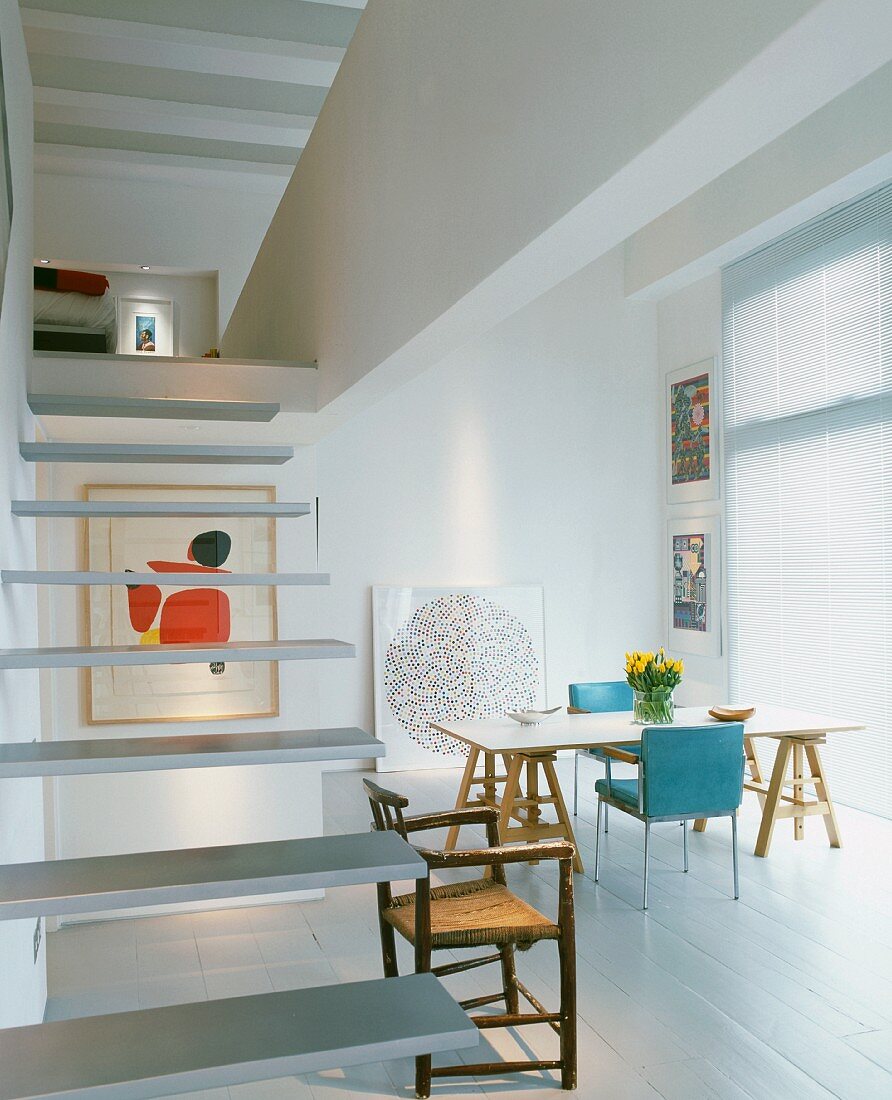 Floating stairs and dining area in open-plan living space