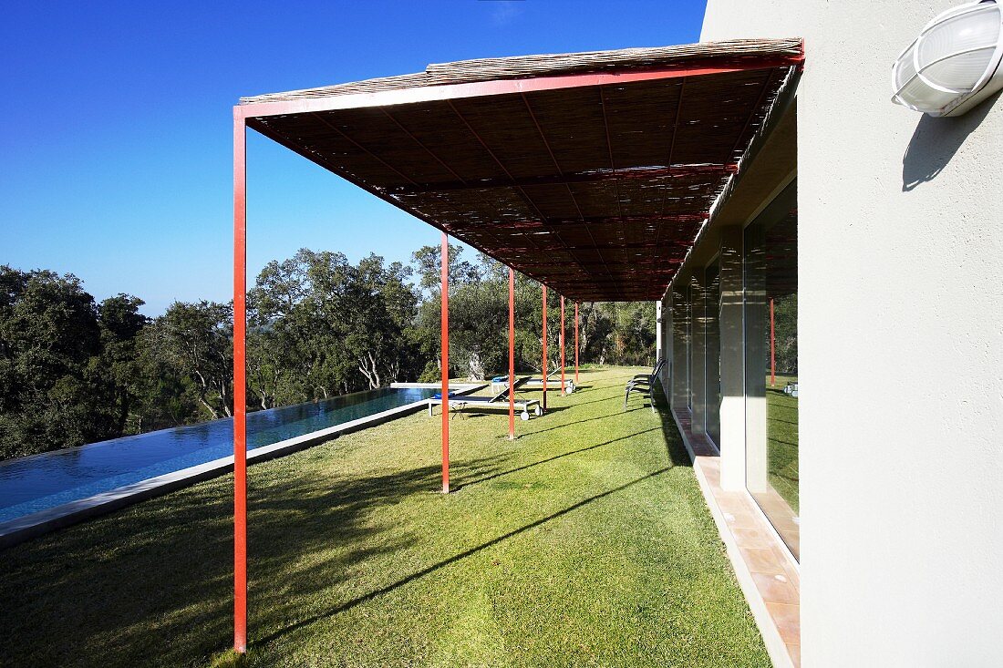 Modern house with veranda and long, narrow swimming pool