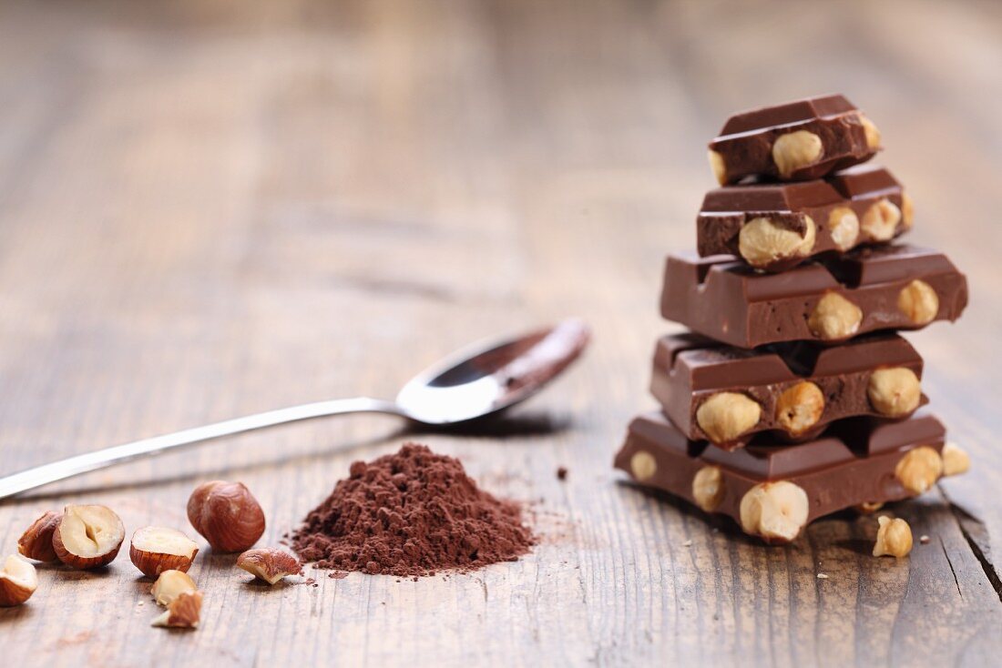 Stacked nut chocolate, cocoa powder, hazelnuts