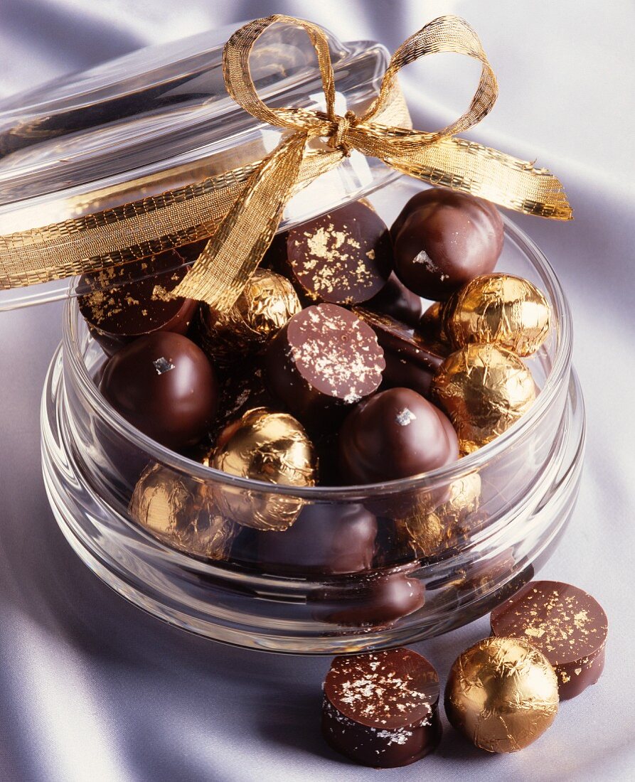 Various chocolate pralines with gold leaf