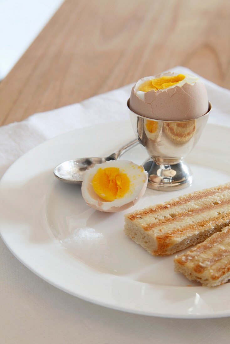 Boiled egg, top removed, and toast