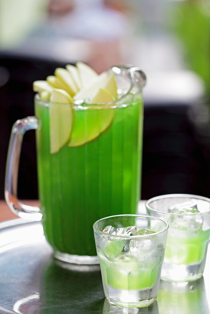 Green apple vodka in a glass jug