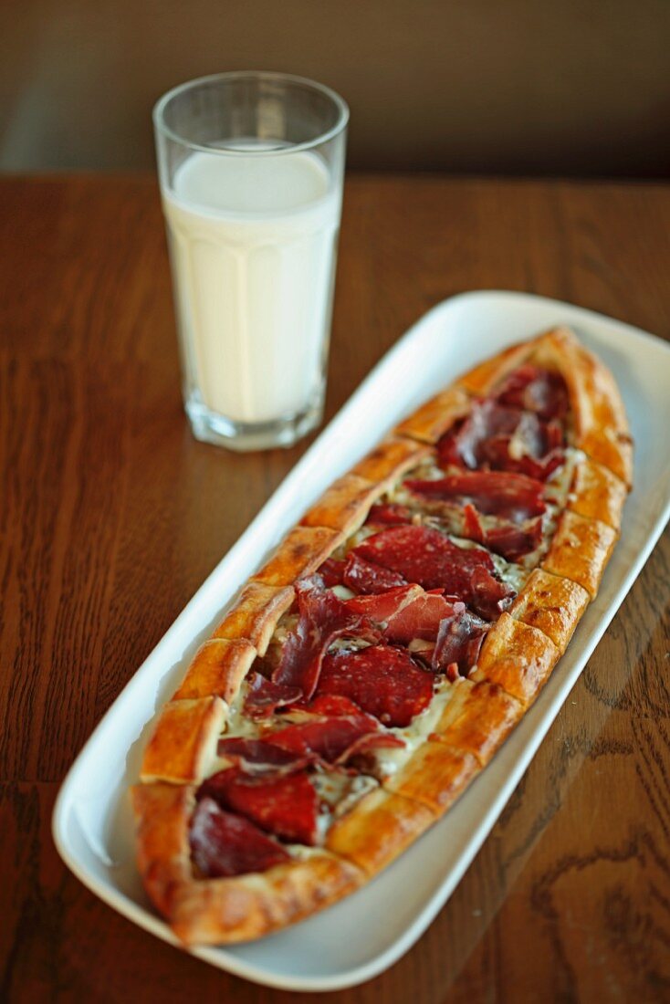 Pide (Turkish flatbread) with air-dried ham