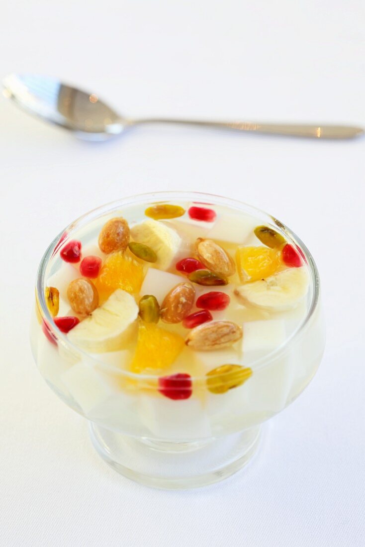 Dairy dessert with fruit and pistachios in rose water (Turkish)