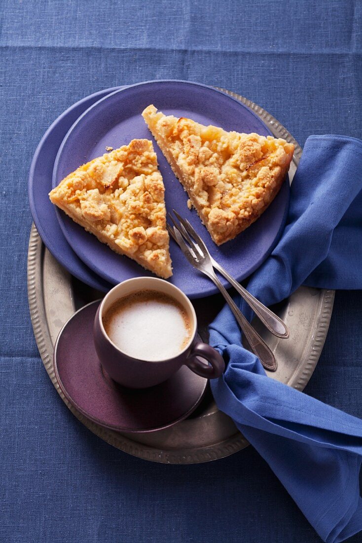 Apfelkuchen mit Streuseln und eine Tasse Cappuccino