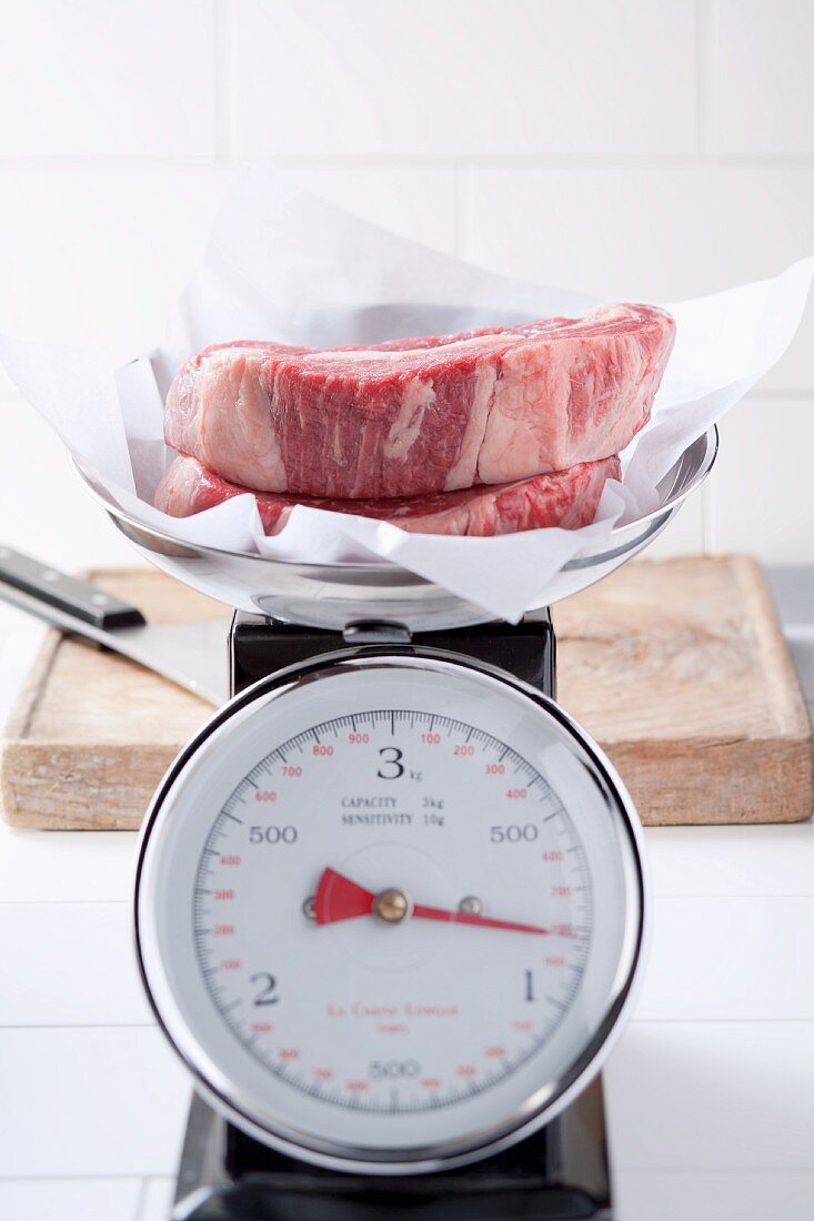 Rib eye steaks on scales