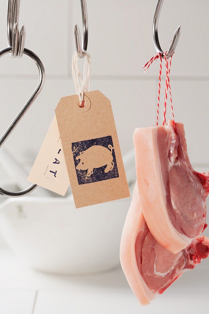 Butcher's hooks, labels and pork chops