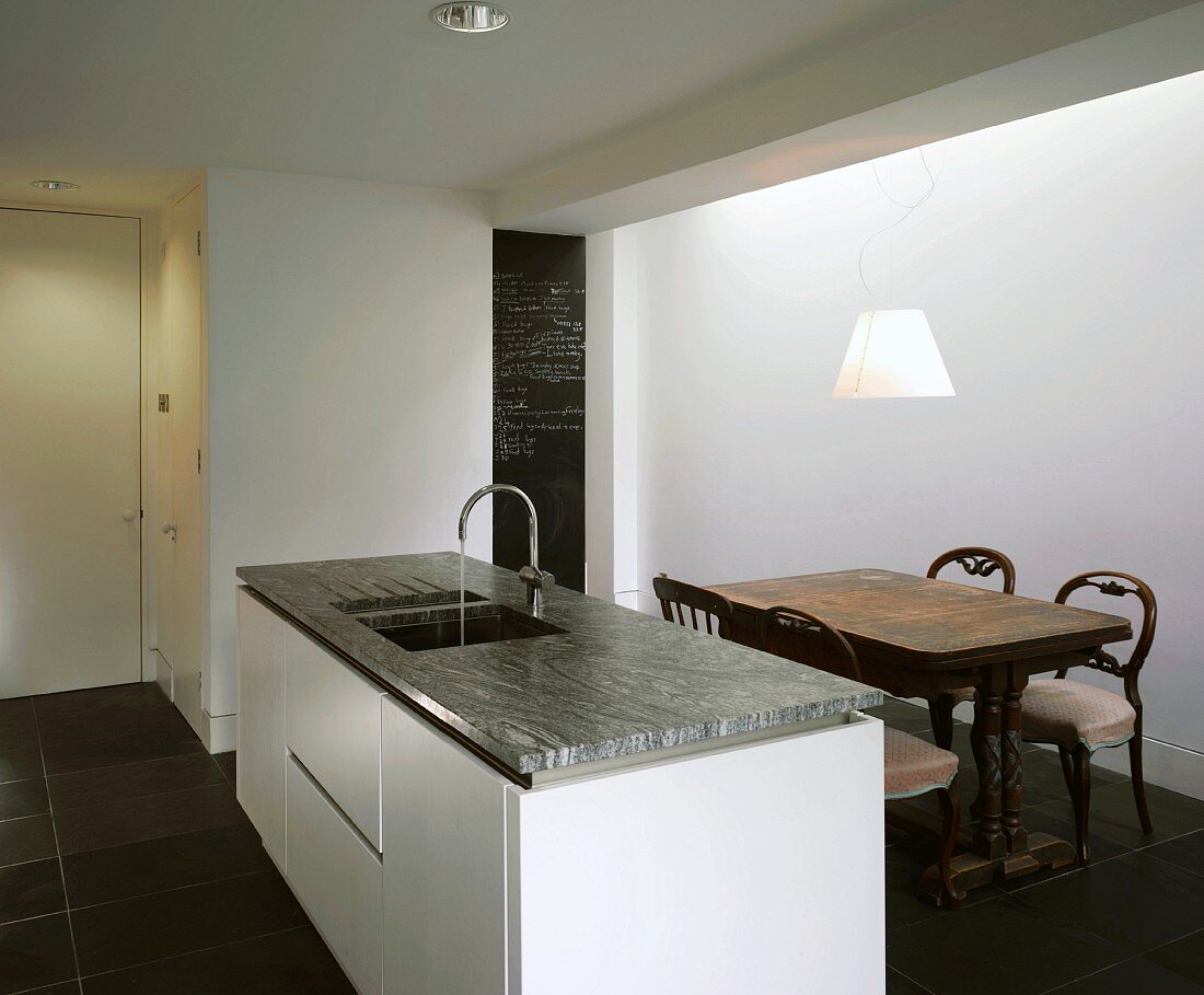 Modern kitchen island with wooden dining table & chairs