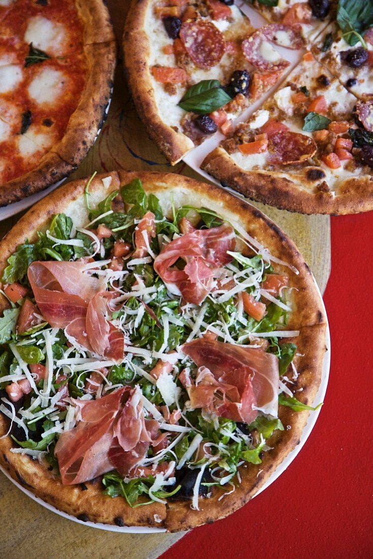 Three Assorted Pizzas; Prosciutto Salad, Pepperoni and Olive, Mozzarella and Basil; From Above