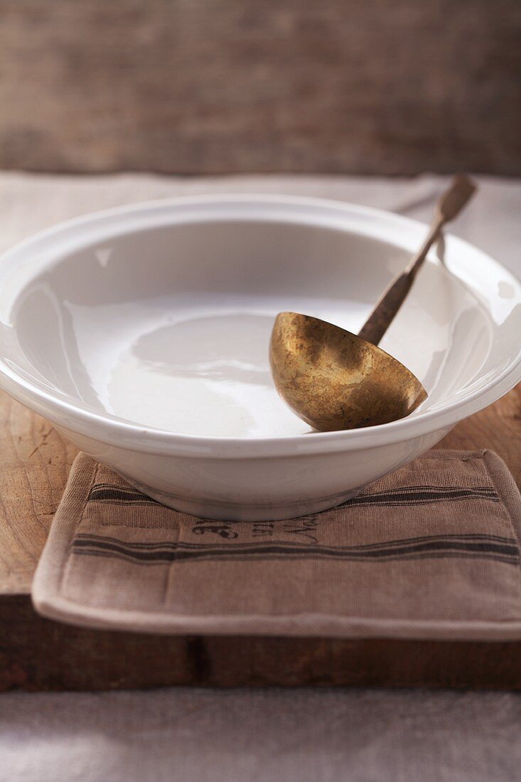 A soup bowl with a ladle