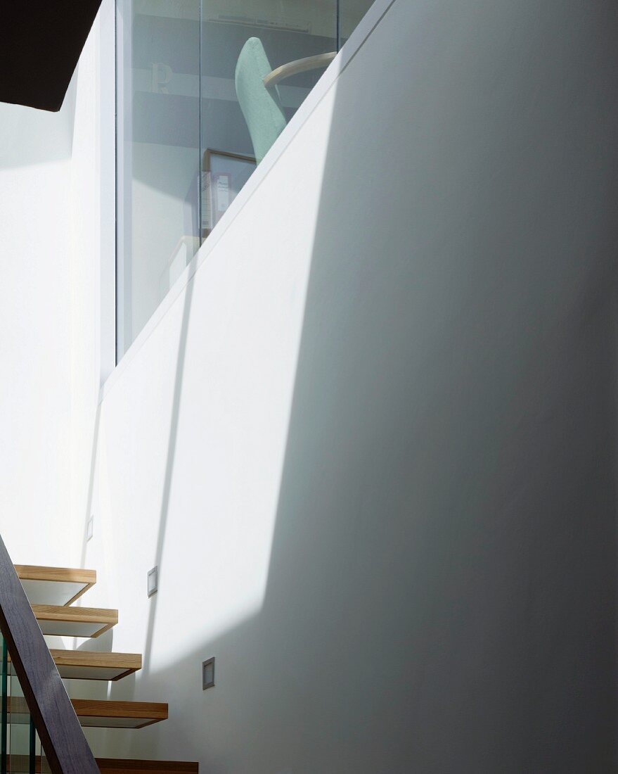 Contemporary stairwell with window and view of chair