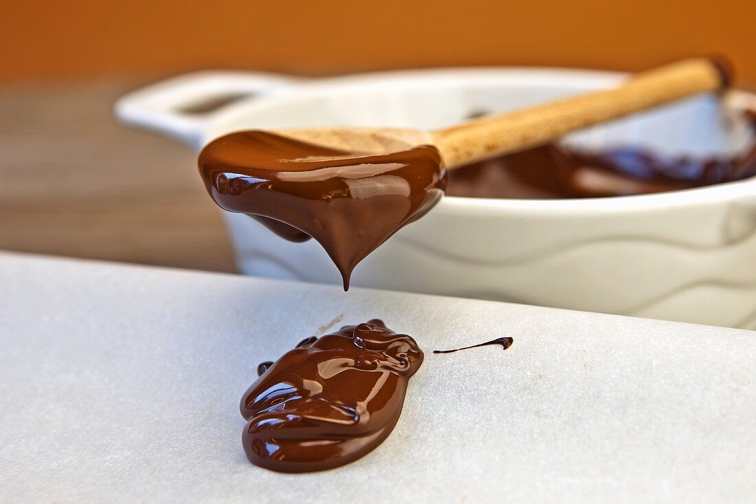 Melted chocolate dripping from a spoon