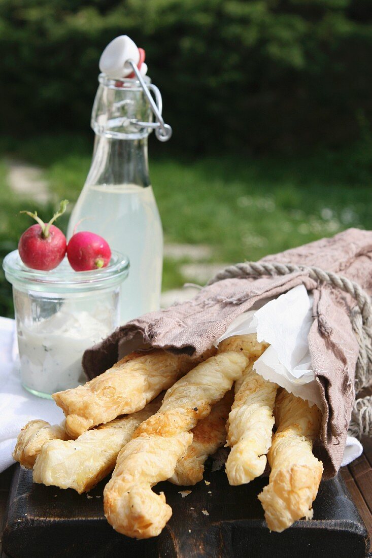 Puff pastry cheese sticks, a dip, radishes and homemade lemonade