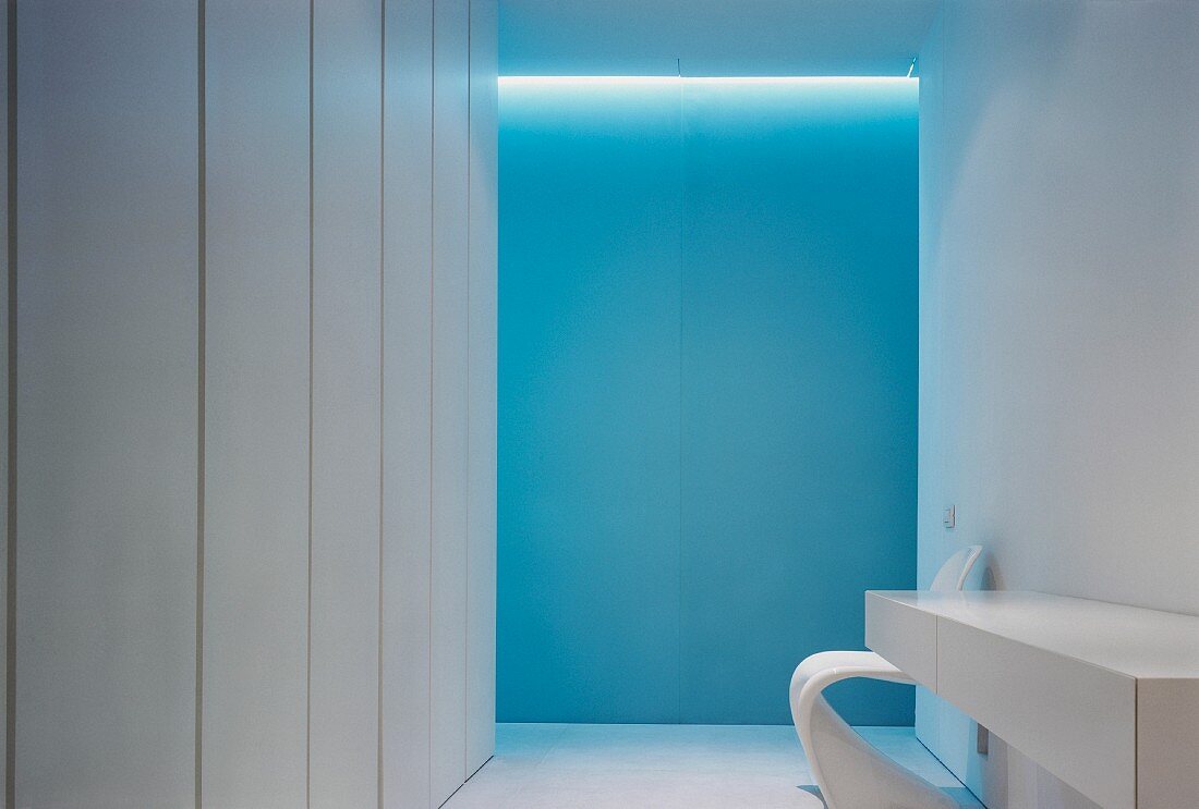 Narrow, white sideboard with drawers in minimalist bathroom