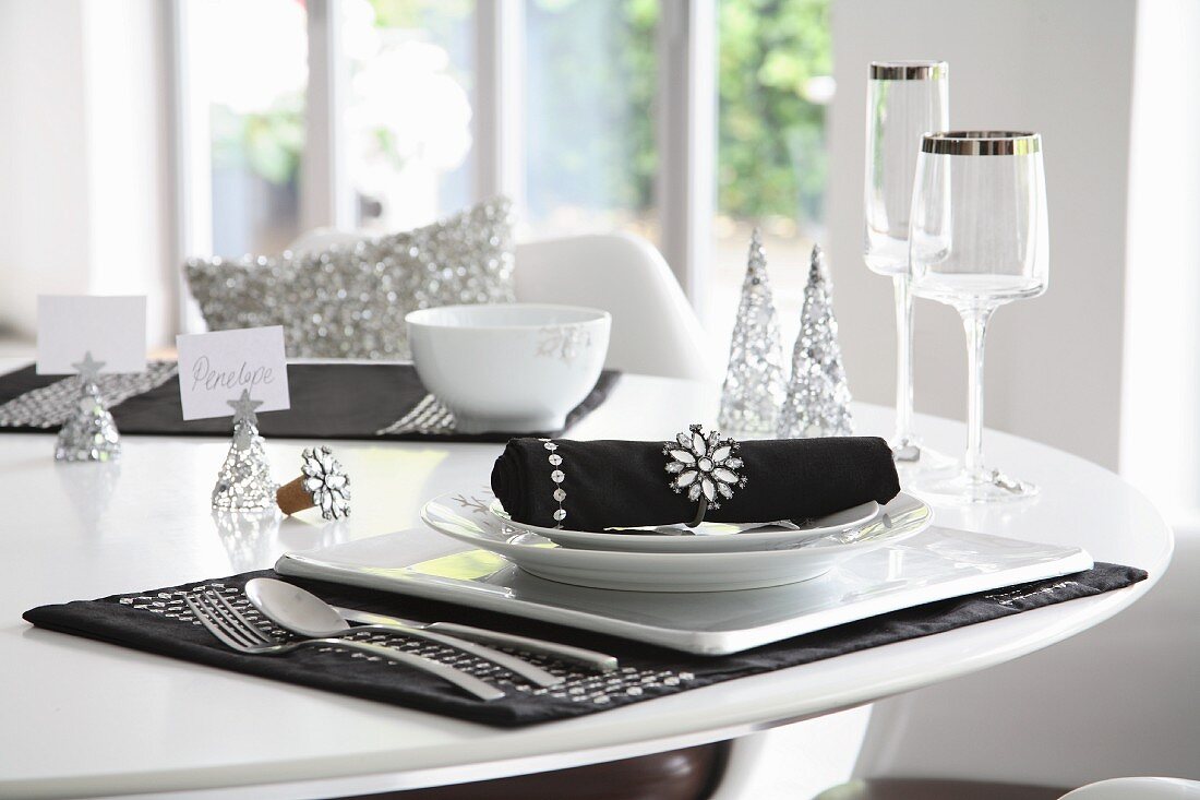 Elegant black and white place setting with silver ornaments