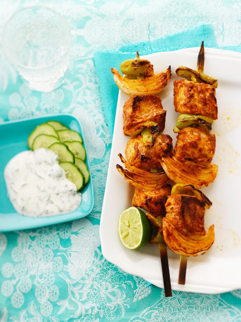 Spicy fish kebabs with onions and tzatziki