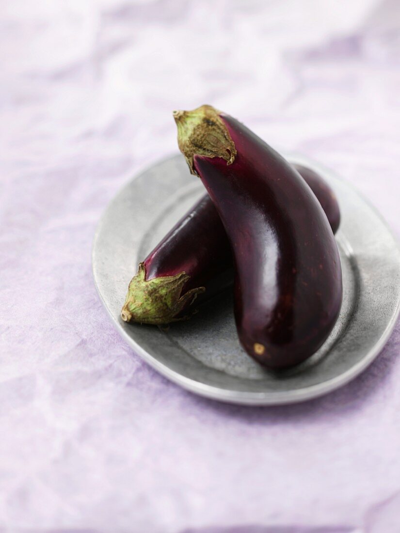 Two aubergines on a plate