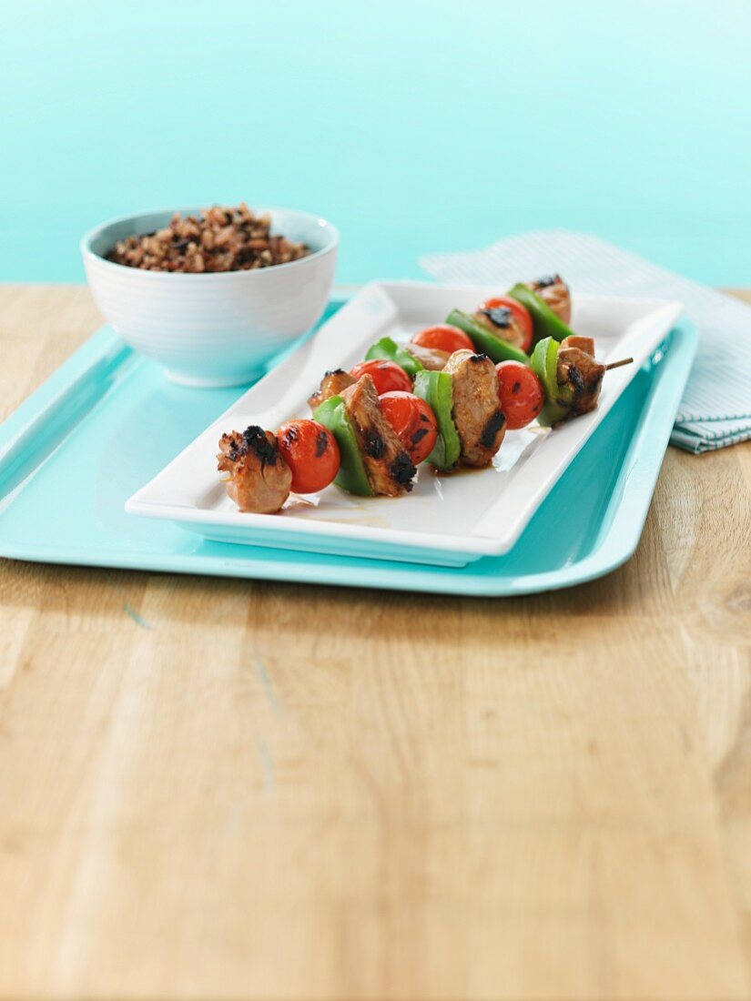 Grilled pork kebabs with tomato and pepper