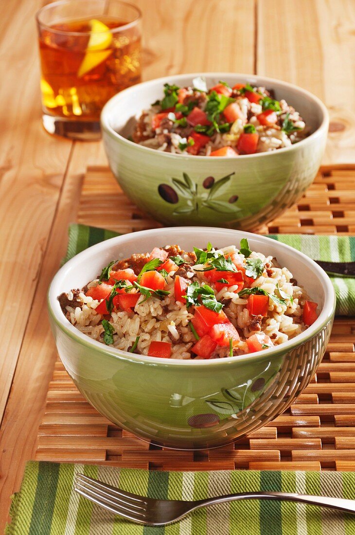 Two Bowls of Dirty Rice with Chopped Beef, Sausage, Tomatoes and Parsley