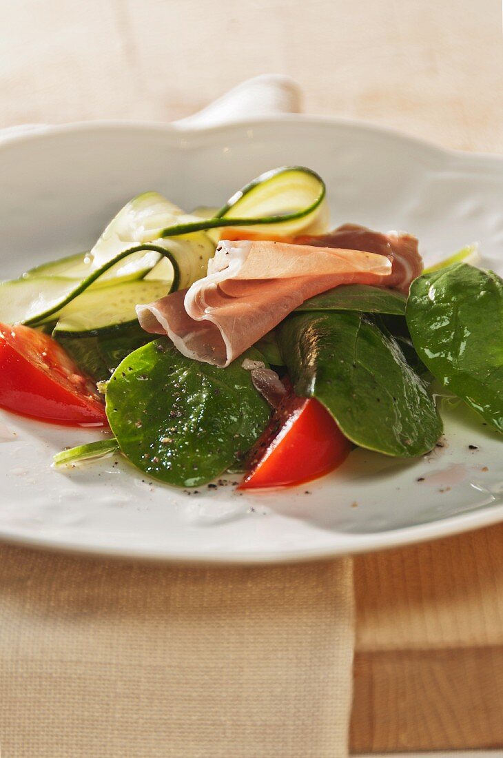 Fresh Spinach Salad with Tomatoes, Zucchini and Prosciutto Tossed with a Vinaigrette