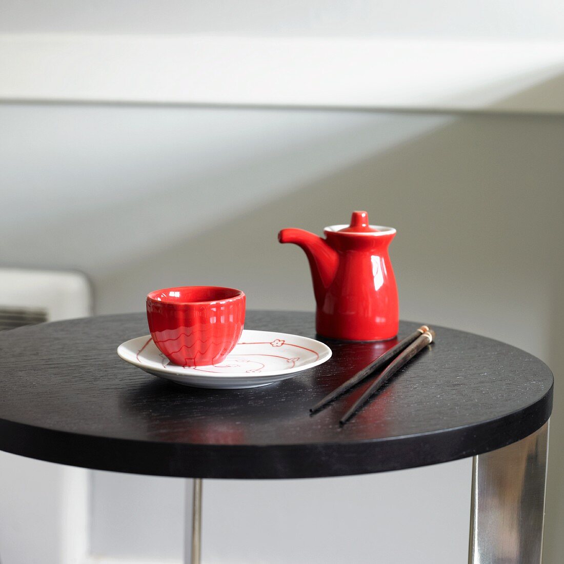 Red and White Asian Dishware on a Table with Chopsticks