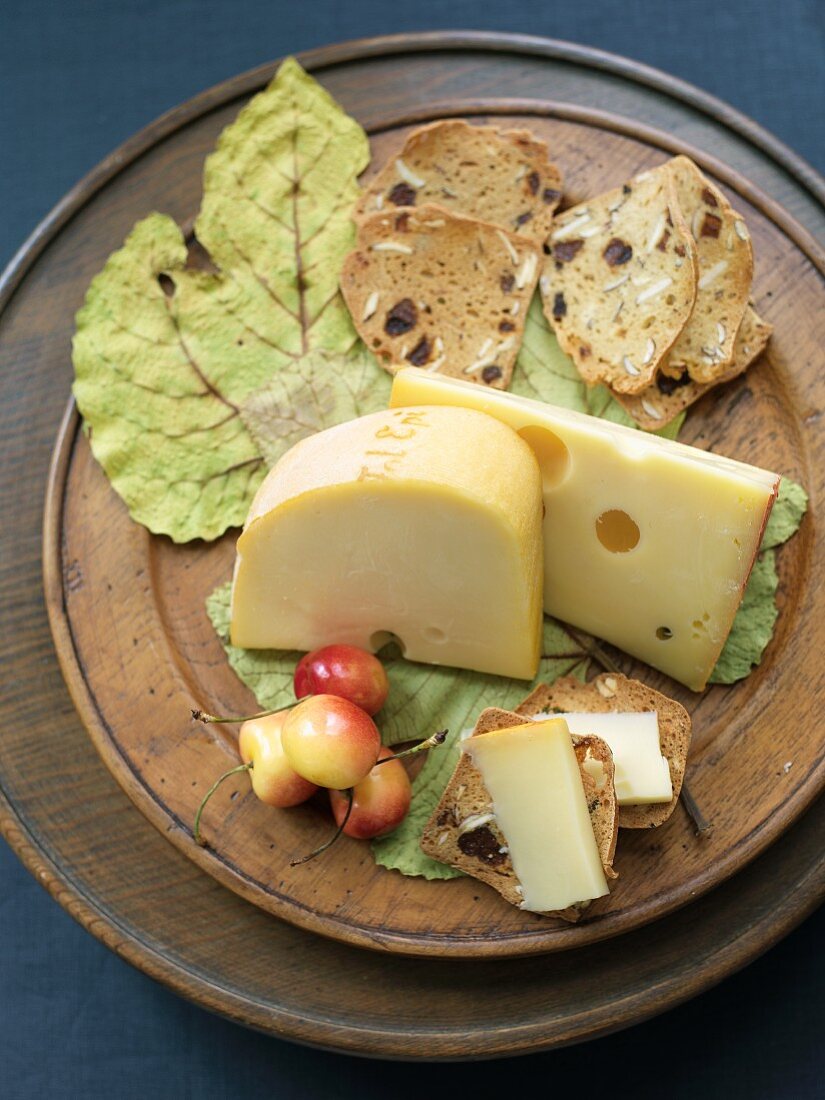 Semi Soft Cheeses with Crackers on a Wooden Dish