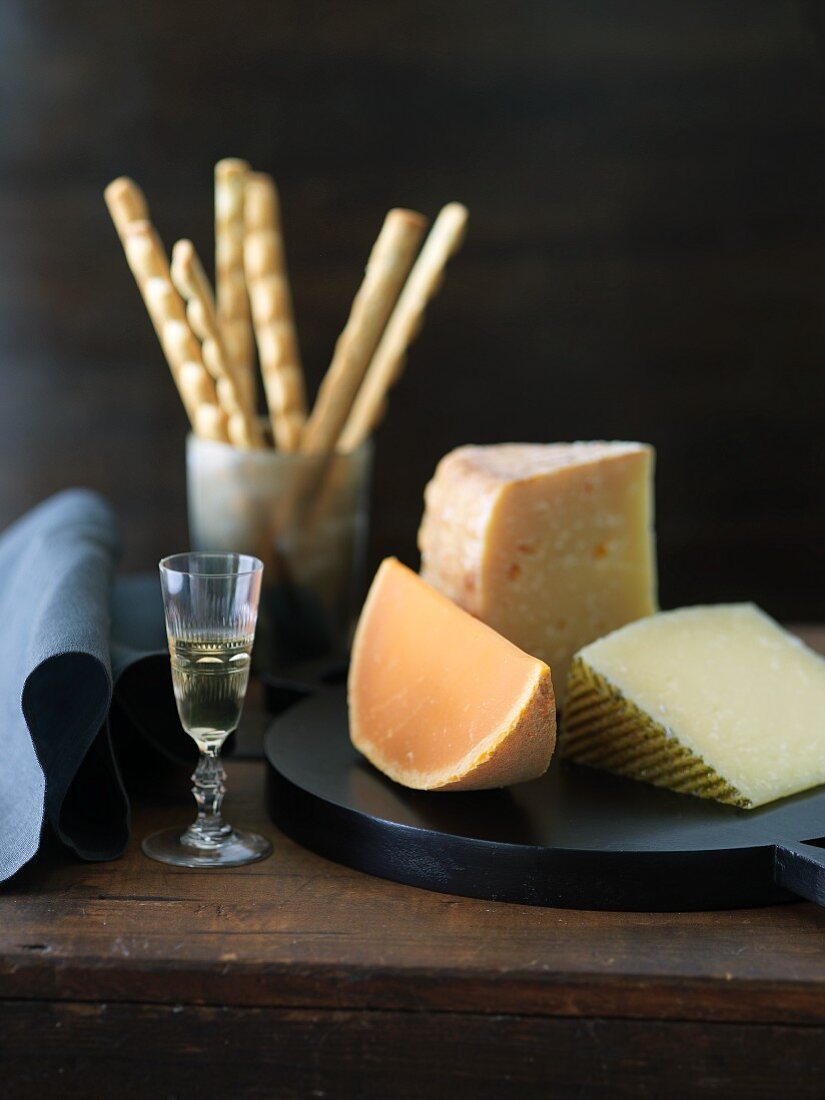 Three Hard Cheeses, Mimolette, Gran Queso and Manchego; Glass of Sweet Dessert Wine; Bread Sticks