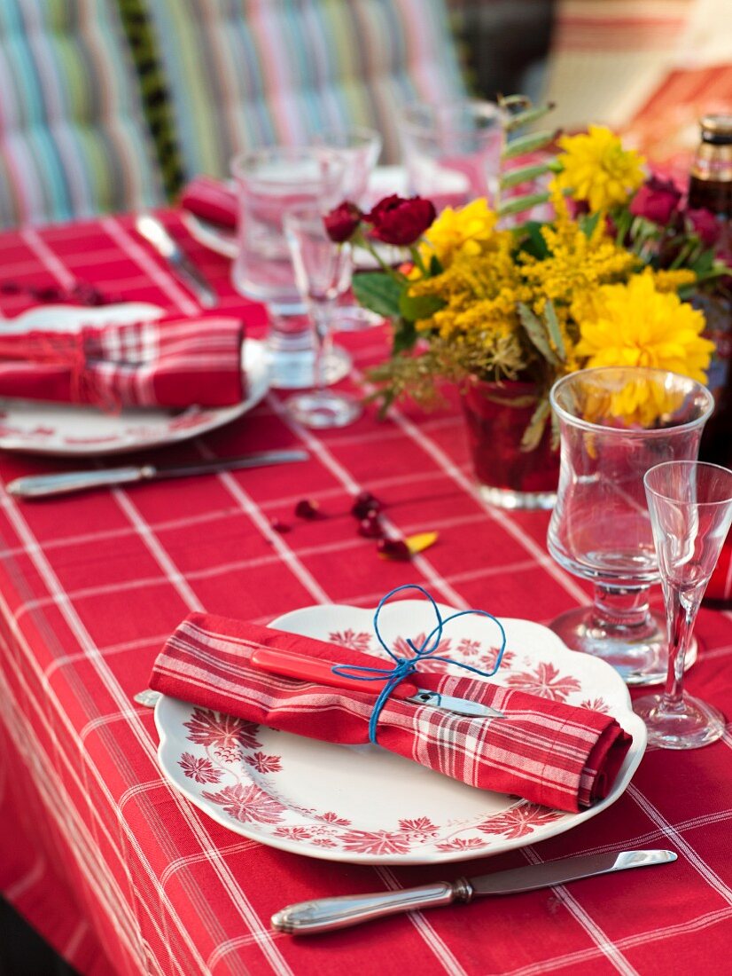 Table set with red cloth for crayfish party in garden