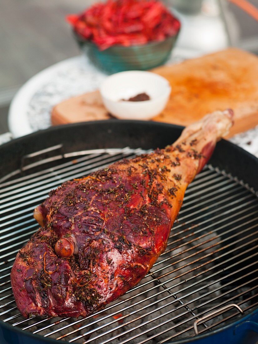 Marinated leg of wild boar on barbecue