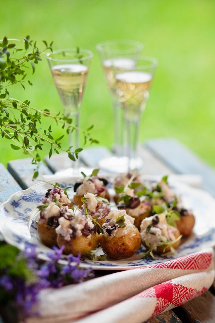 Baked potatoes with asparagus topping and basil