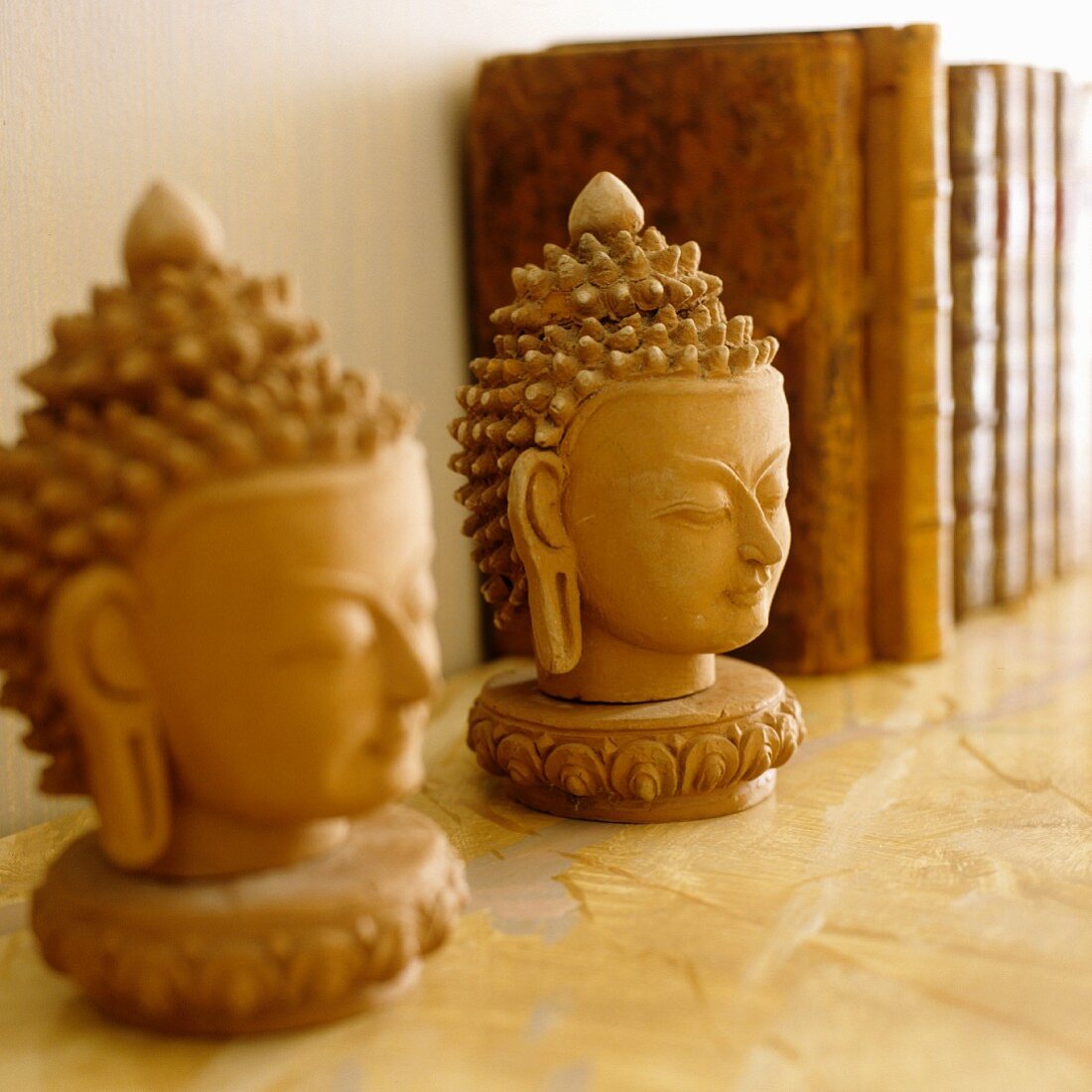 Plaster Buddha's heads on shelf