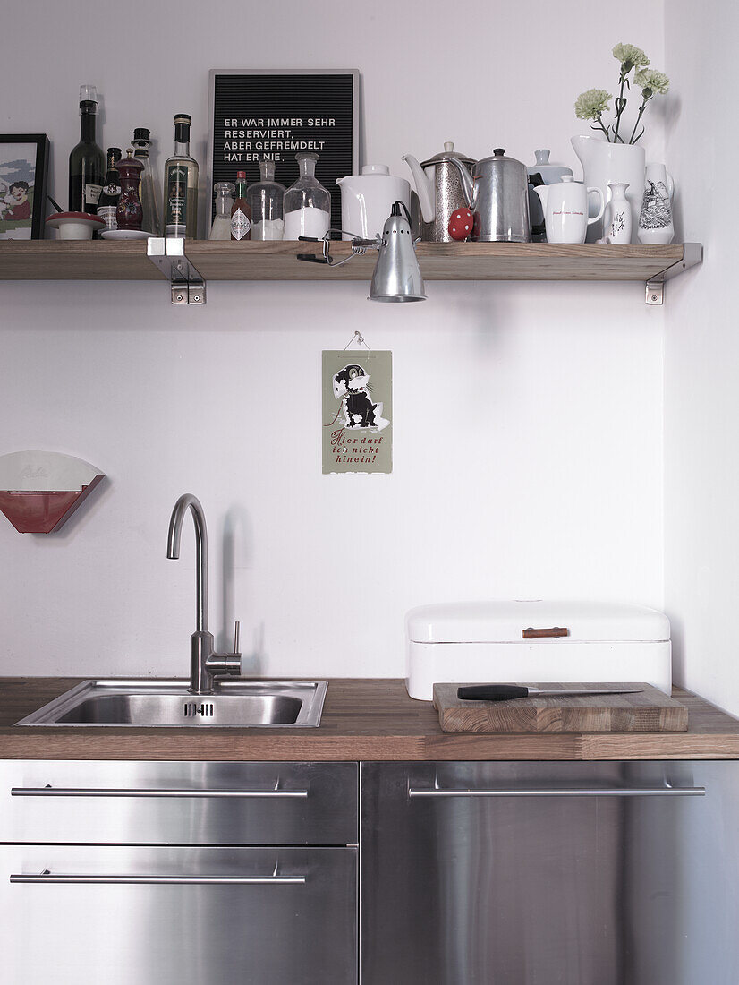 Kitchen unit with stainless steel cabinets and wooden worktop