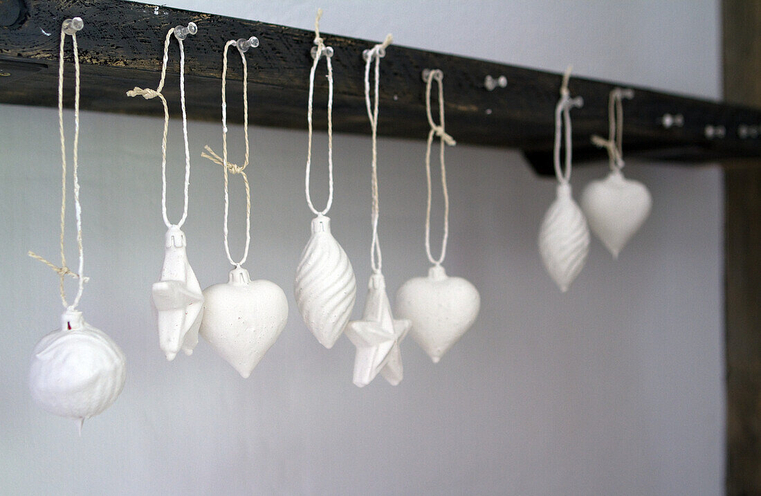 White Christmas decorations on a rustic wooden moulding